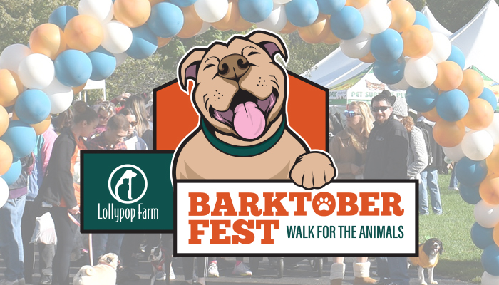 A very happy pitbull is holding a sign that reads: Lollypop Farm Barktoberfest Walk for the Animals